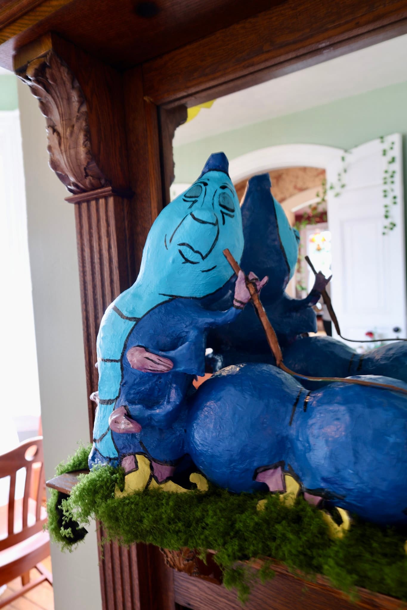 Close-up of the handmade blue Caterpillar on the Garden Room mantel