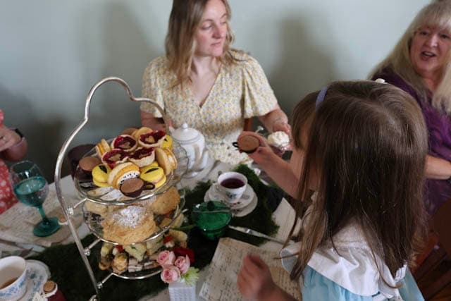 Three-tier Alice afternoon tea with Cheshire Cat eye macarons and heart cherry tarts