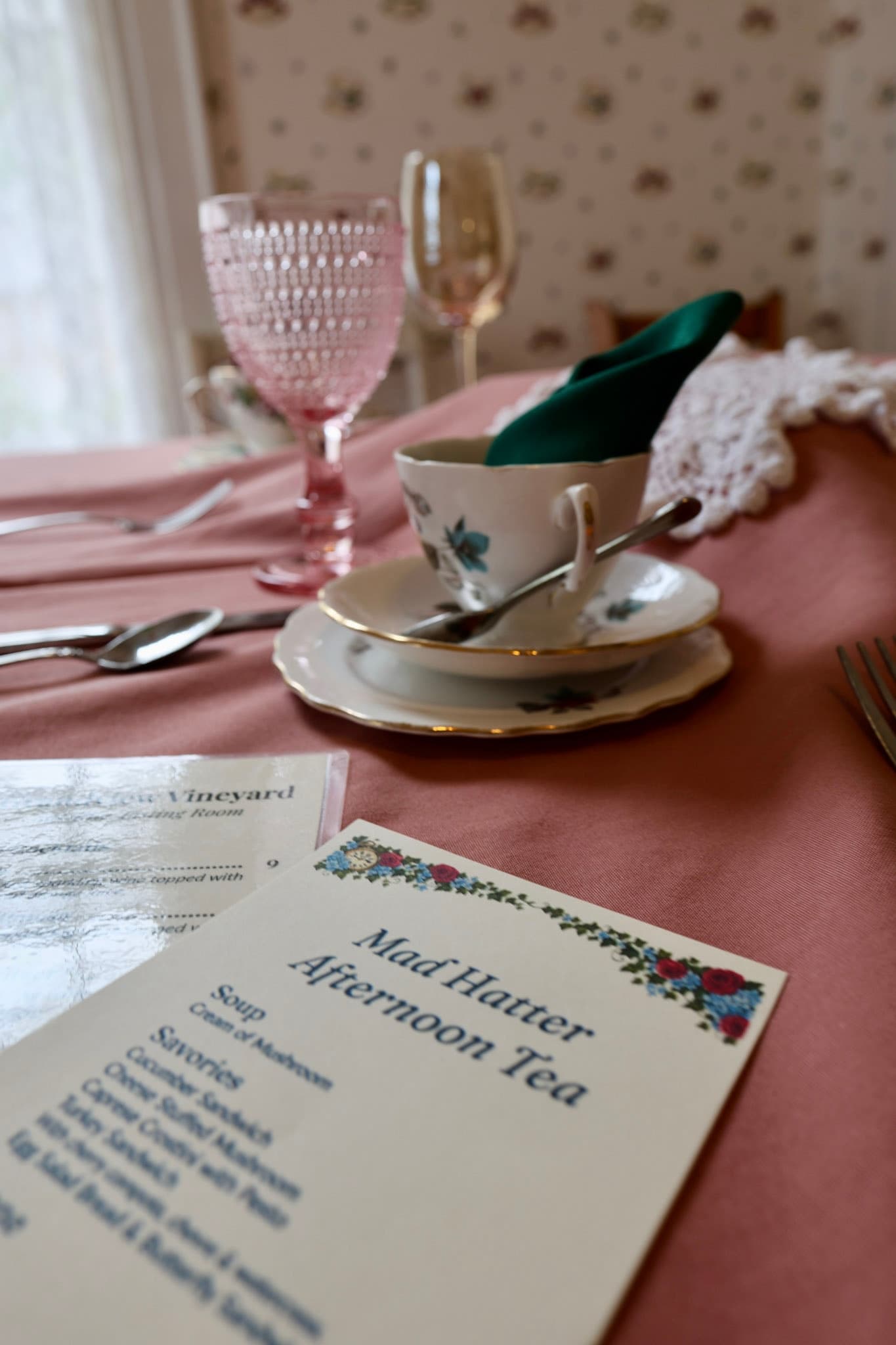 Mad Hatter afternoon tea menu and place setting with crooked lace doily