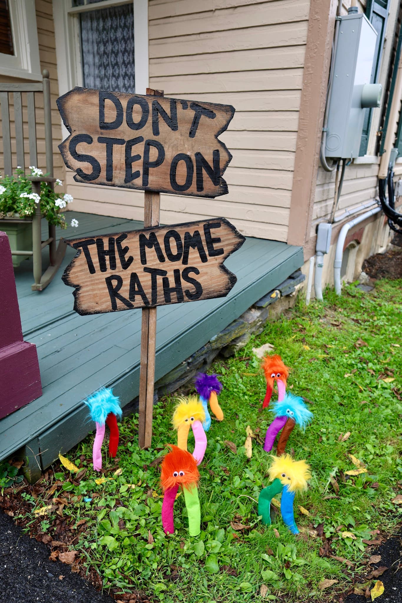 Don't Step on the Mome Raths wooden sign with colorful Mome Raths in the grass